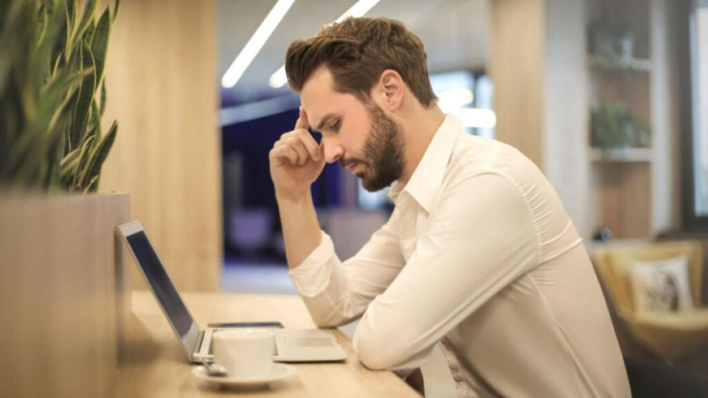 Man looking at the laptop seriously