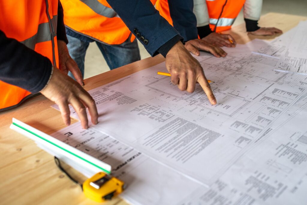 A group of construction workers reviewing blueprints