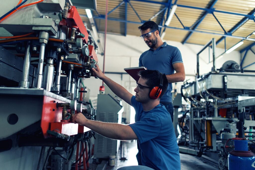 Two men operating a machine