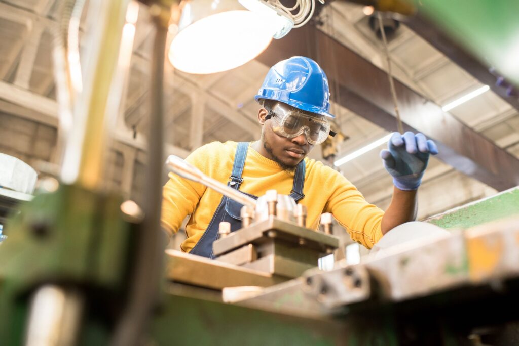 Factory worker operating machine