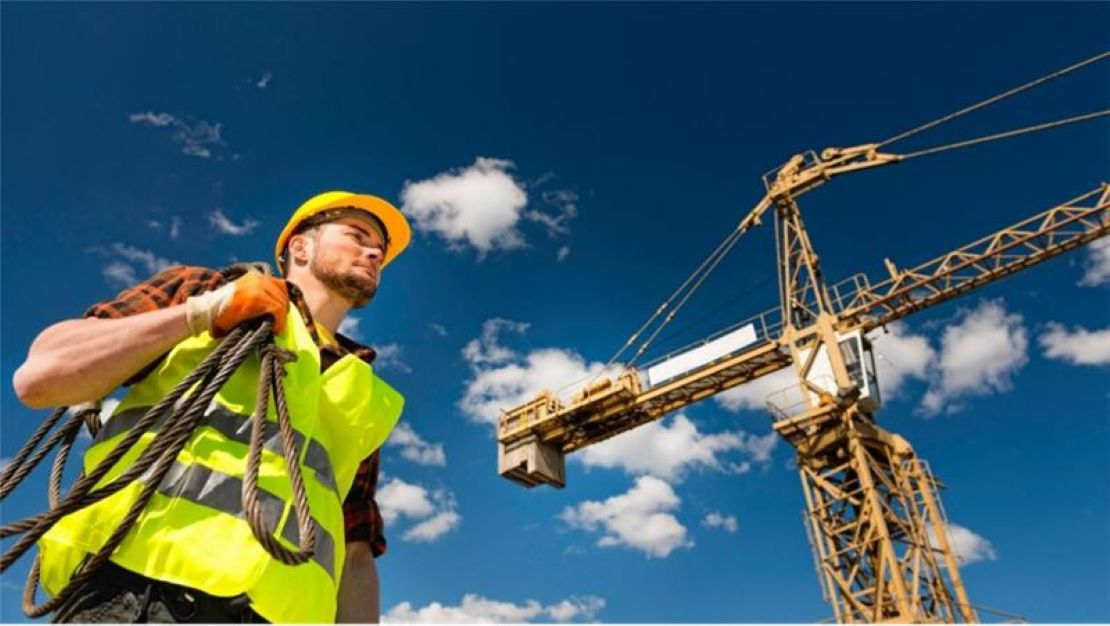 Construction Worker and Crane at the background