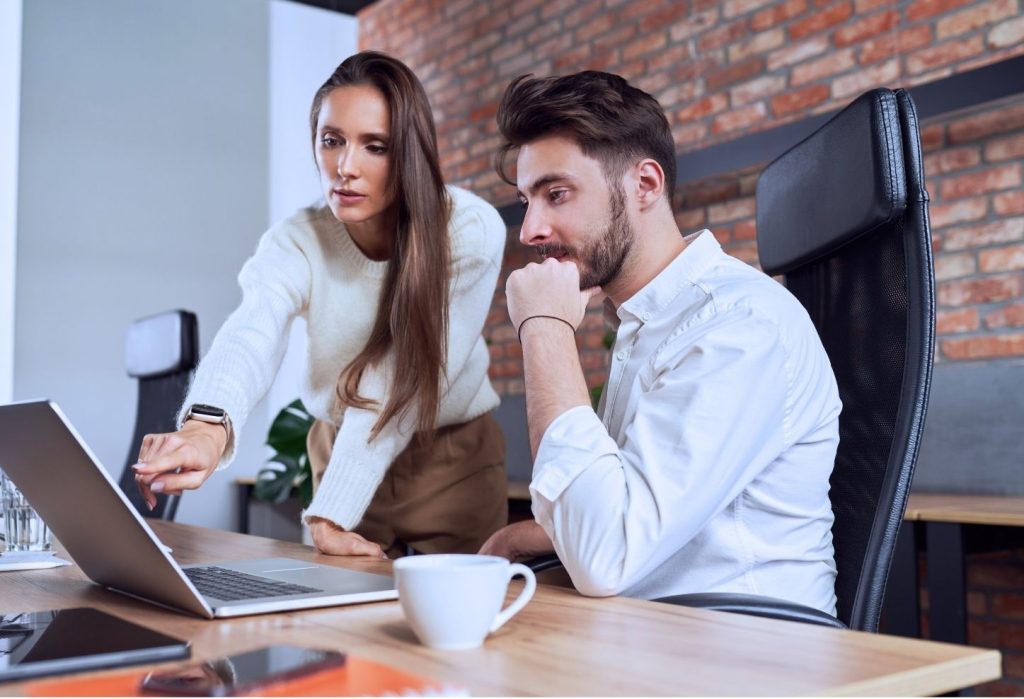 Two People Looking at the Laptop